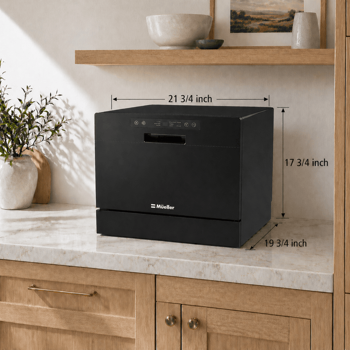 Black small countertop dishwasher with door closed on a kitchen countertop with measurement drawings showing the exact size of the dishwasher. 