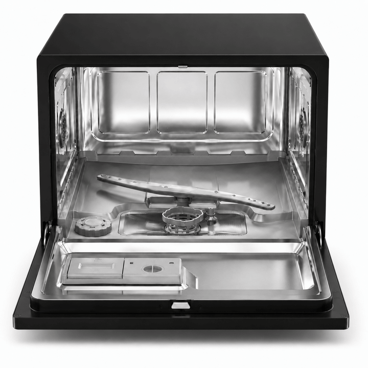 Interior view of small countertop dishwasher with shelf removed to show stainless steel inside, spray arm, filter, salt department and dishwashing cleaner compartment. dishwasher on a white backgrounds.