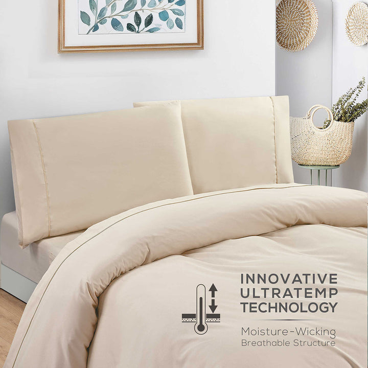 Beige comforter set on a bed with 'Innovative Ultratemp Technology' label.