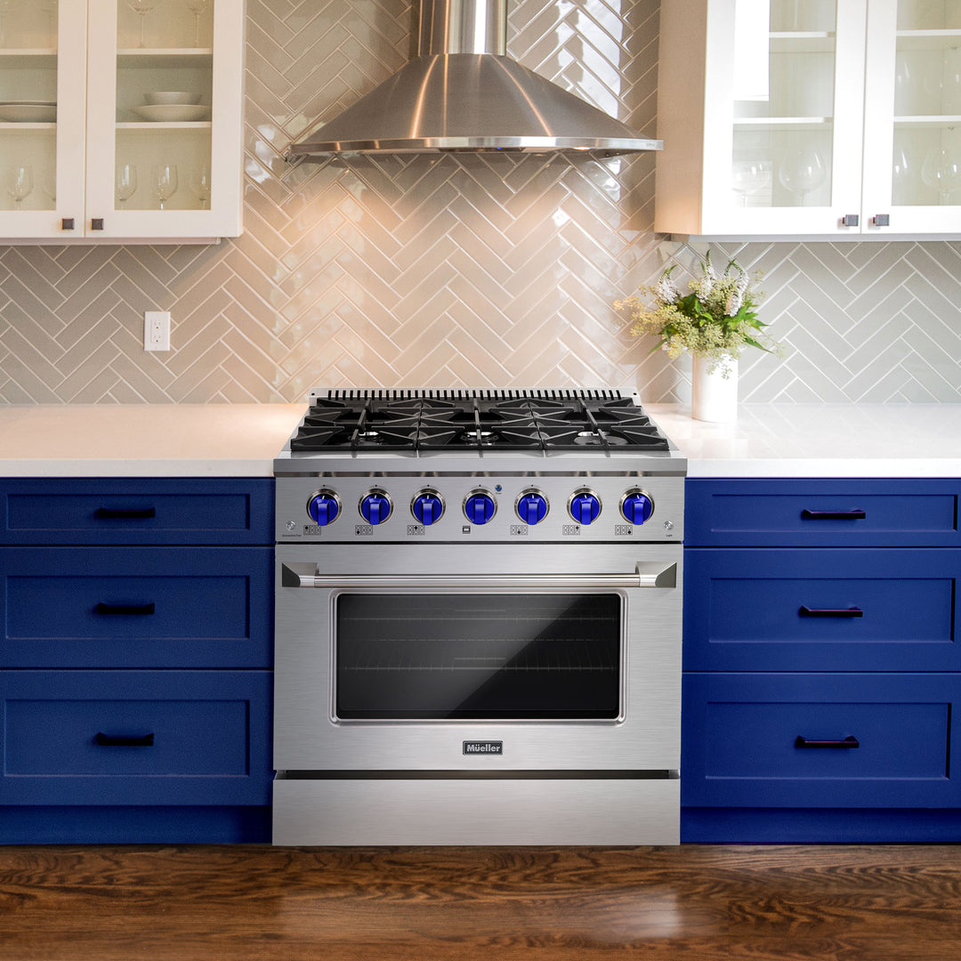 Mueller-36-gas-range-BLUE-knobs in a kitchen with blue cabinets and a tiled backsplash.