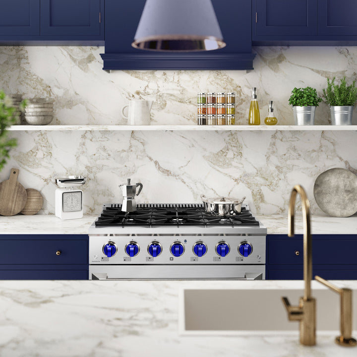 Modern kitchen with blue cabinets, marble backsplash, and stainless steel appliances.