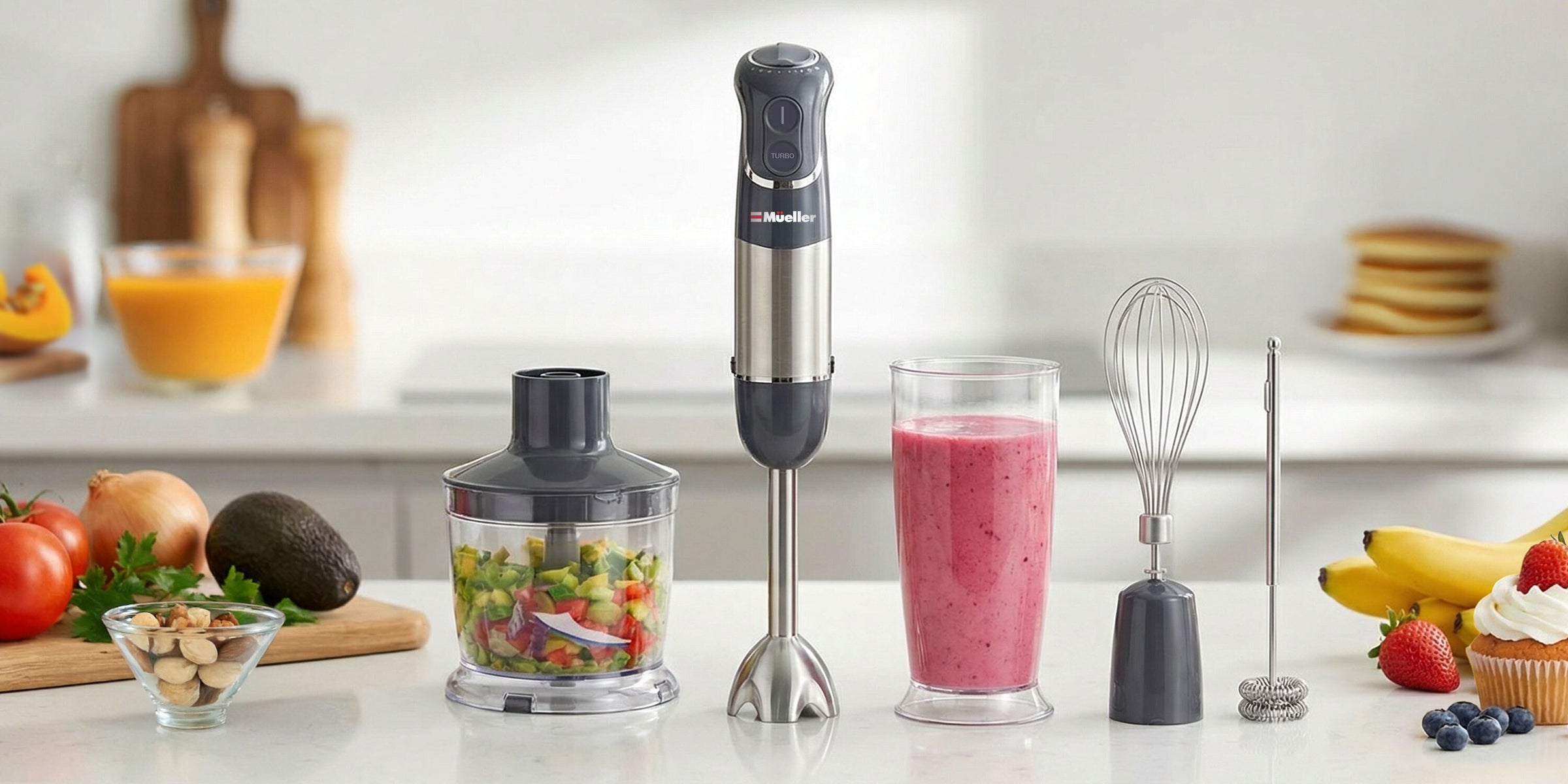 Mueller Hand Blender with ingredients and a smoothie on a kitchen counter.