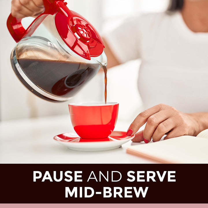 Red kettle pouring coffee into a red cup with text 'Pause and Serve Mid-Brew' on a blurred background.