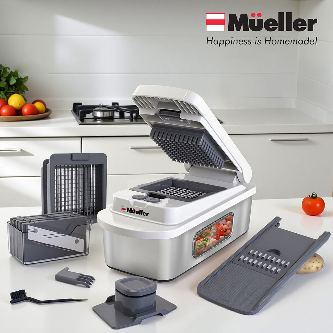 Mueller_8_Blade_Vegetable_Chopper_white stainless steel  with various attachments on a kitchen counter, featuring the brand logo.