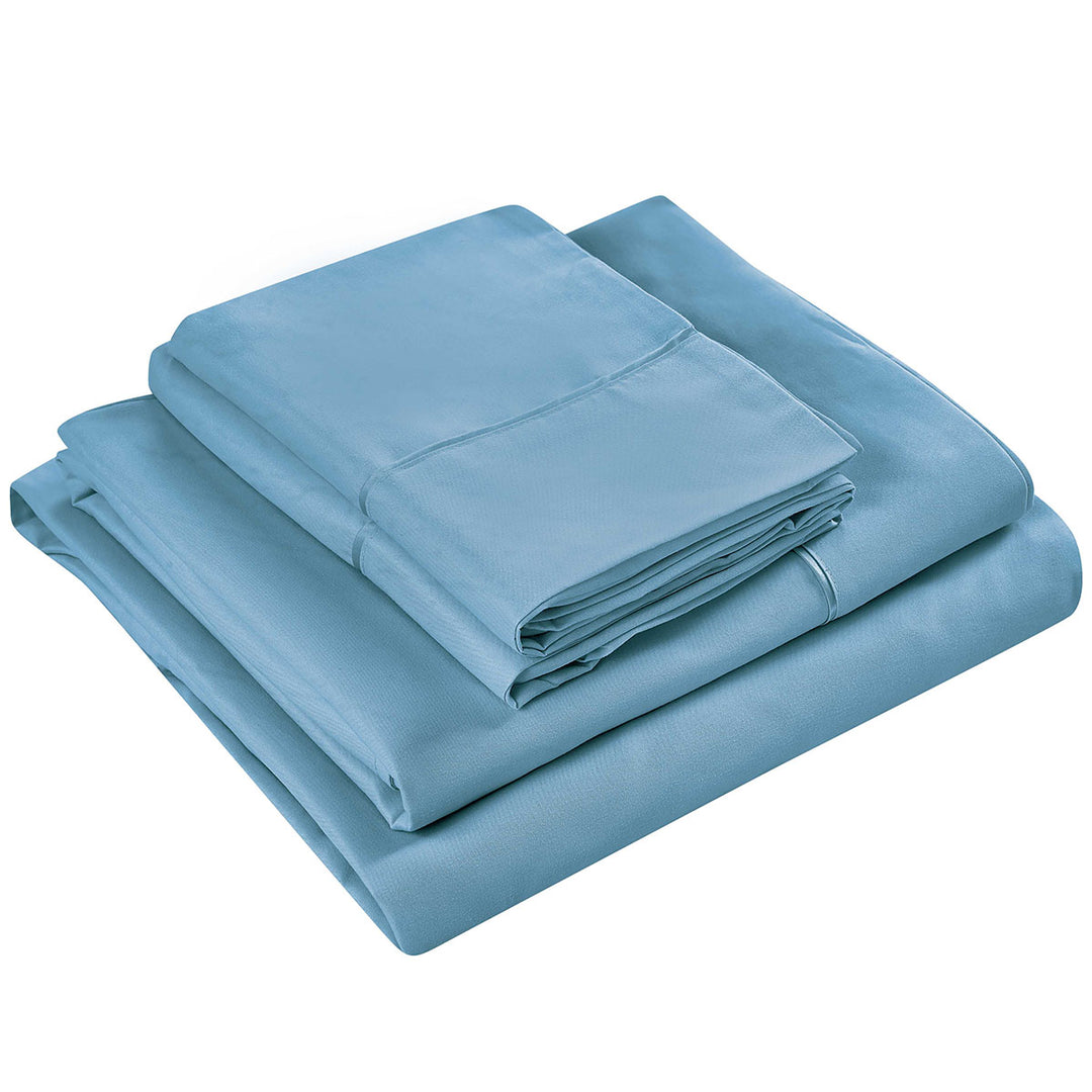 Set of blue bed sheets folded on a white background