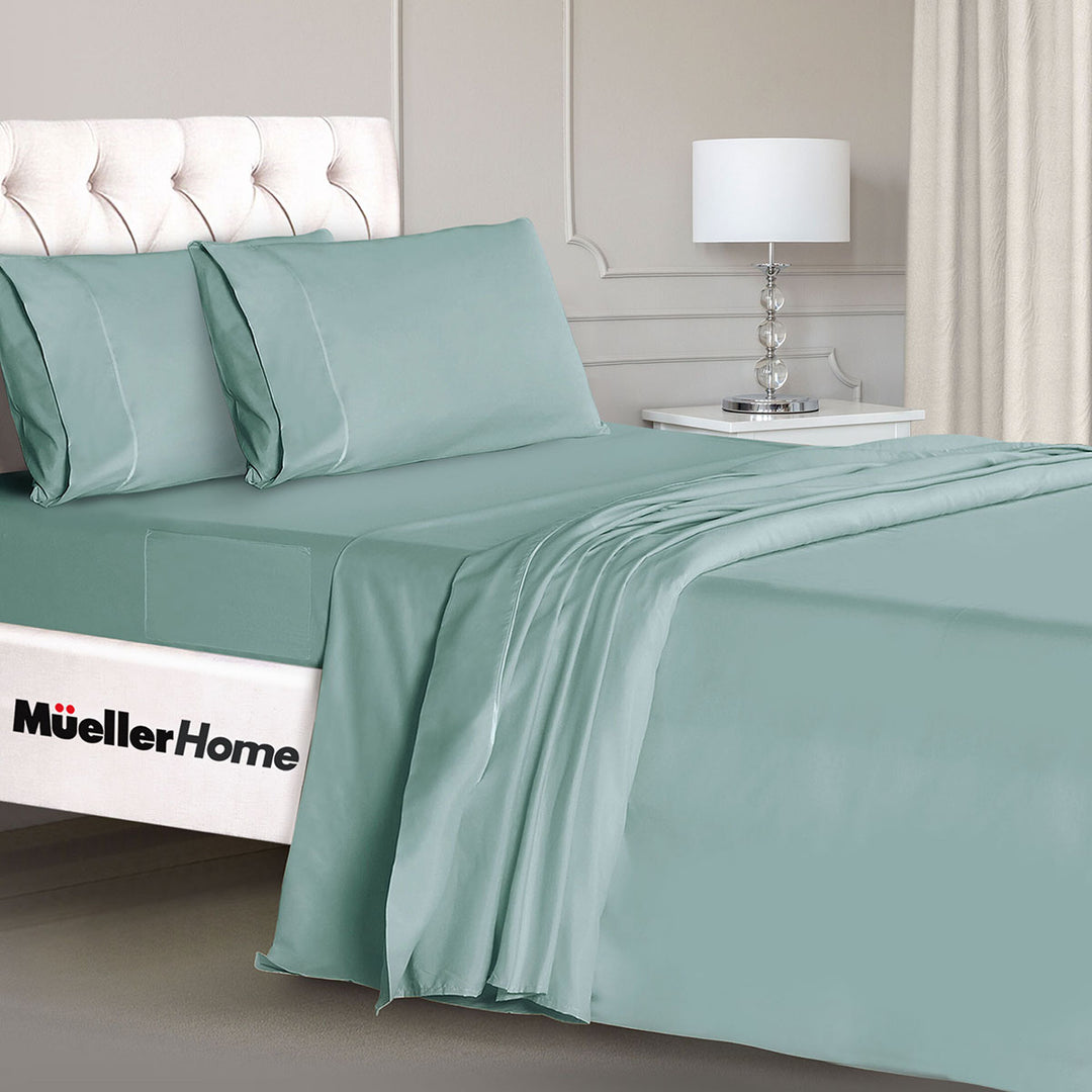 Teal bed sheets and pillowcases on a bed with 'Mueller Home' branding.