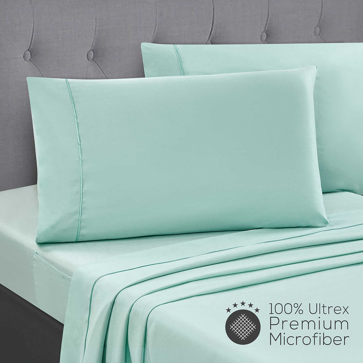 Mueller Bedding-bed-sheets-Twin light green and pillowcases on a bed with a gray headboard, featuring 100% Ultrex Premium Microfiber label.
