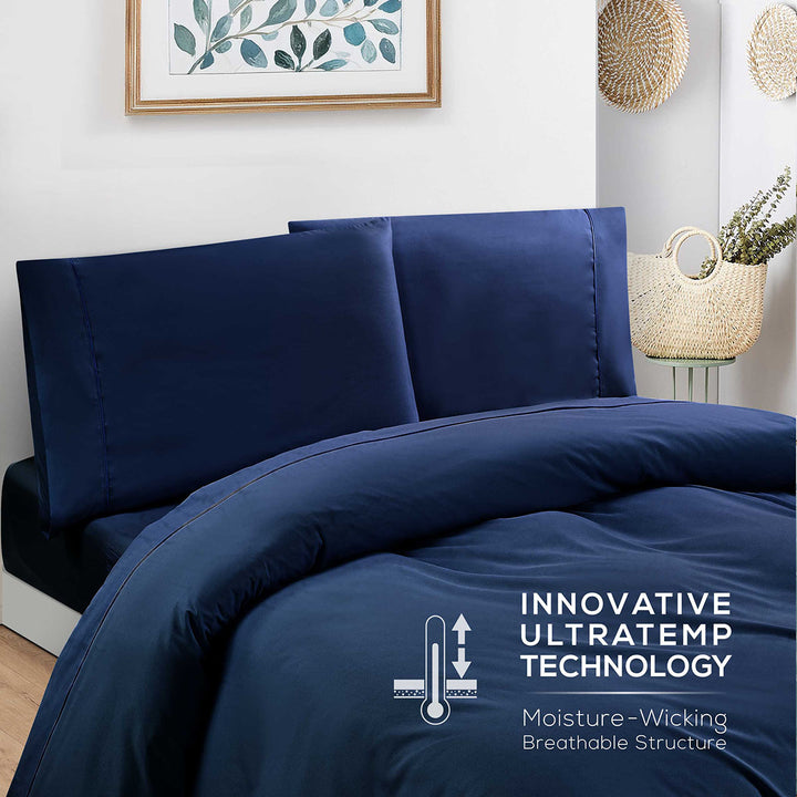 Navy blue bedding set with 'Innovative Ultratemp Technology' label in a bedroom setting.