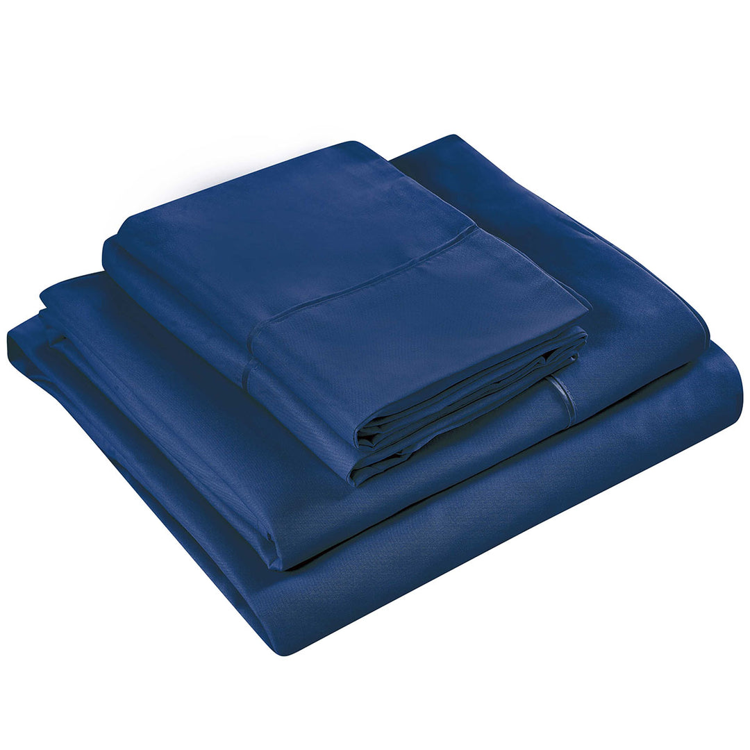 Folded navy bed sheets on a white background