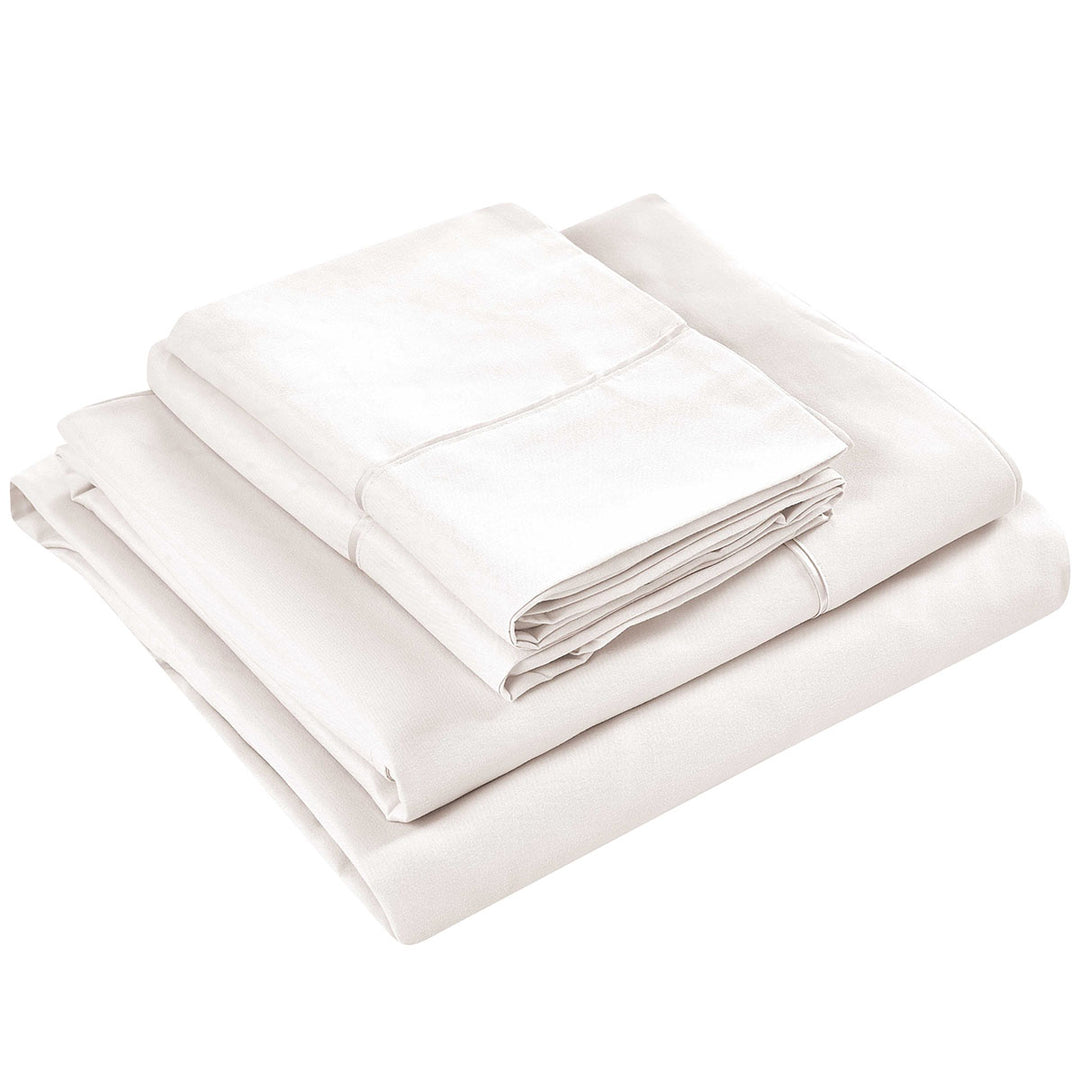 Folded white bed sheets on a white background