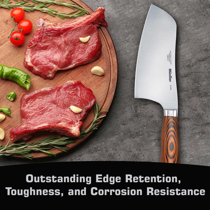 Wooden cutting board with raw meat, vegetables, and a chef's knife on a gray surface.