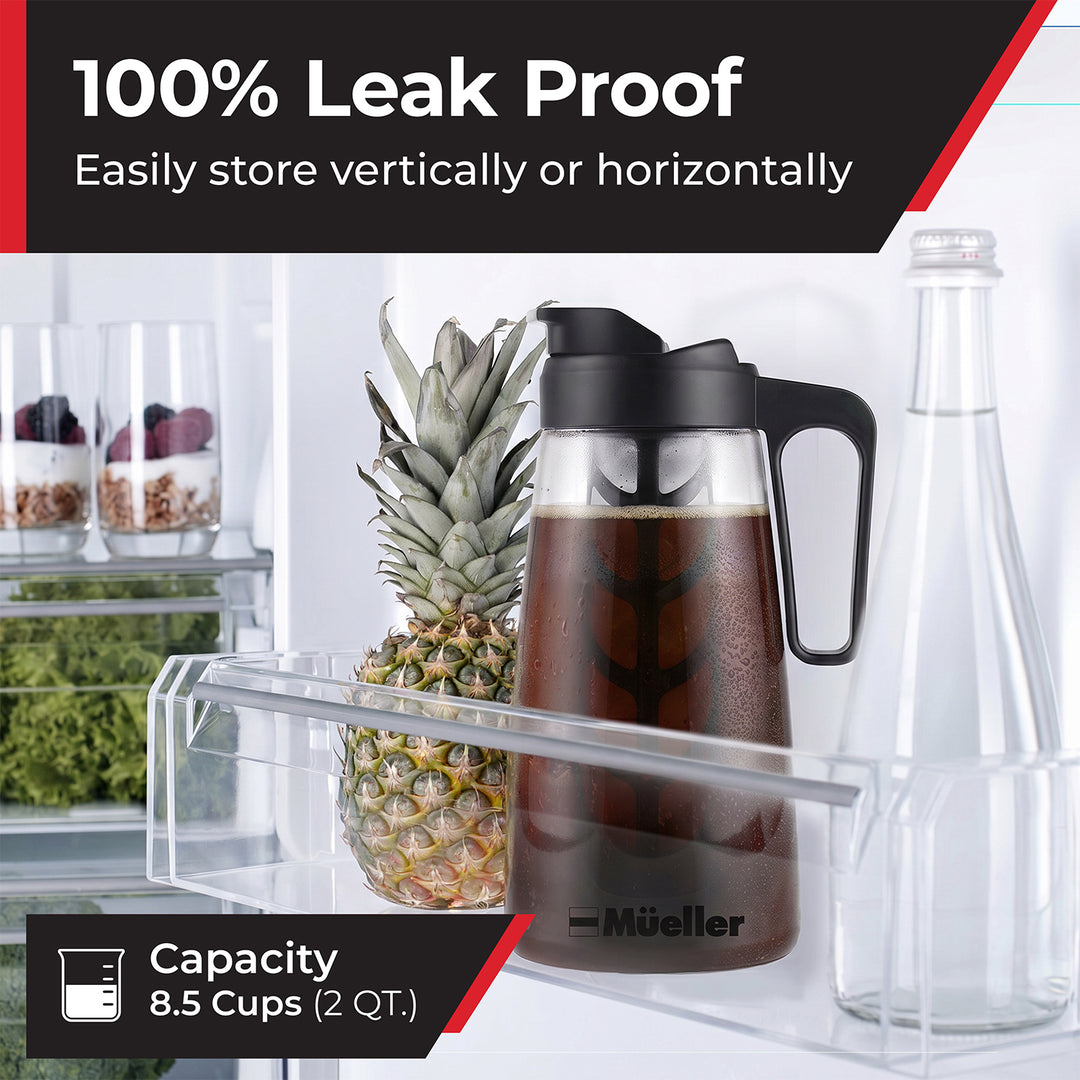 Mueller Cold Brew pitcher in a refrigerator door next to a glass bottle and pineapple. 