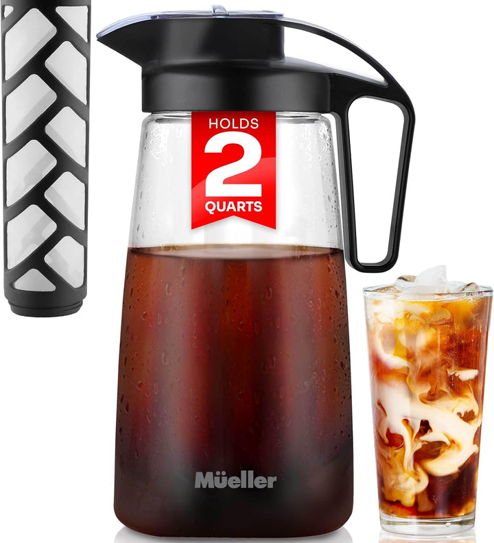 A black and clear glass cold brew pitcher with a lid and a glass of cold brew coffee next to it. The pitcher has a label indicating it holds 2 quarts.