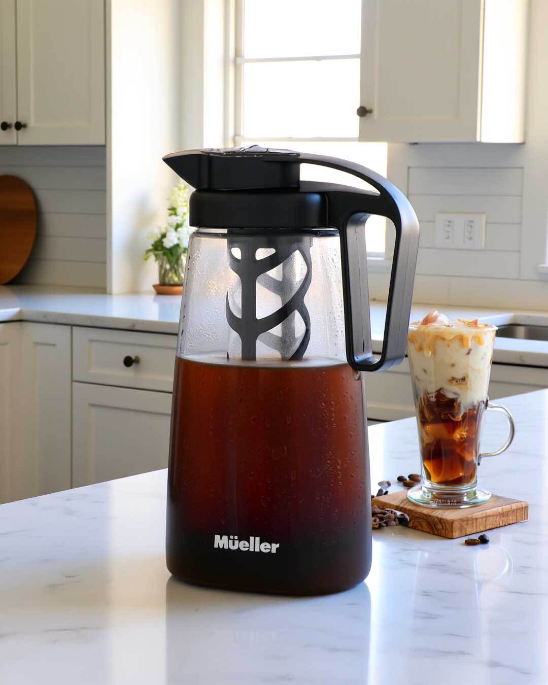 Muller iced coffee maker on a kitchen counter with a glass of iced coffee.