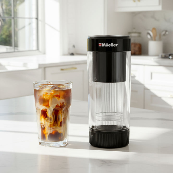 Muller cold brew coffee maker on a kitchen counter with iced coffee.
