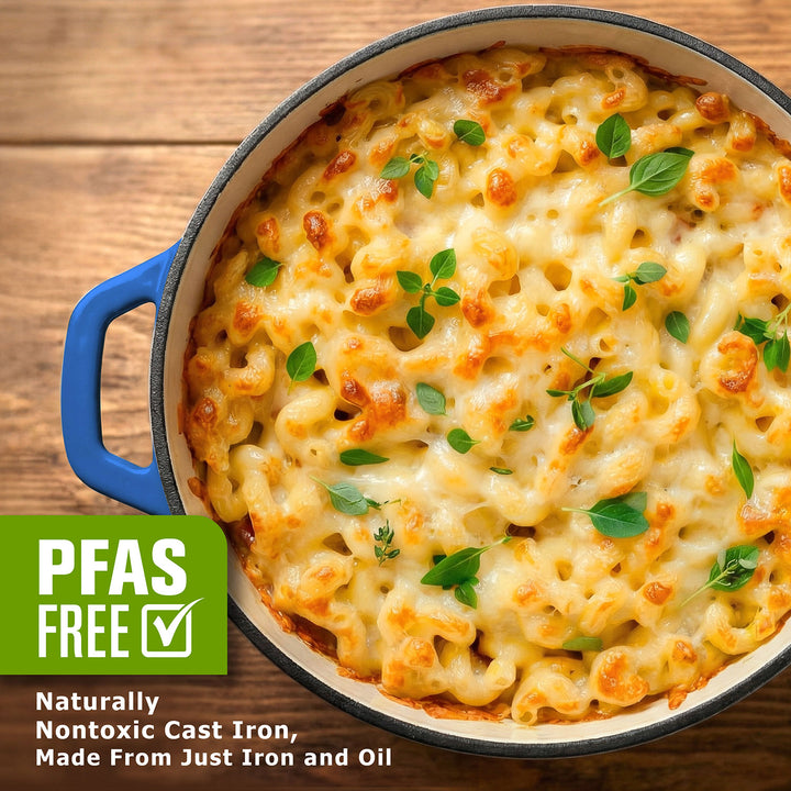 Macaroni and cheese dish in a cast iron skillet on a wooden surface, with PFAS-free label.