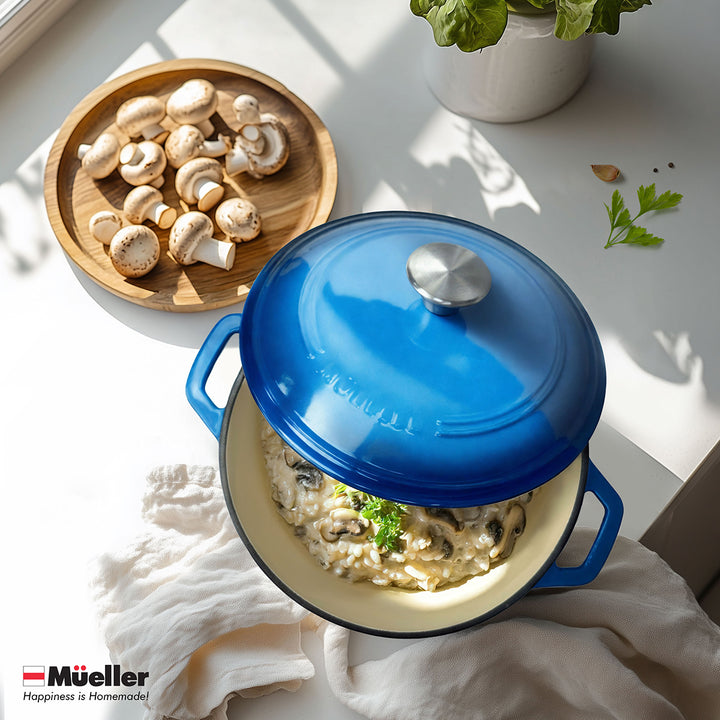 Mueller Dutch Oven Aqua Blue ceramic pot with a lid containing mushroom risotto on a light surface with a bowl of mushrooms and plant.