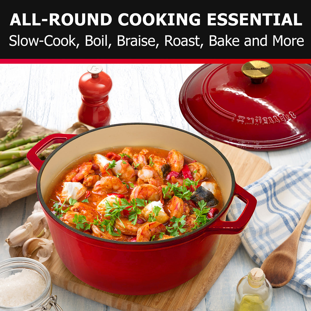 Mueller Dutch Oven Red cast iron cookware with a dish of food on a wooden board, surrounded by ingredients.