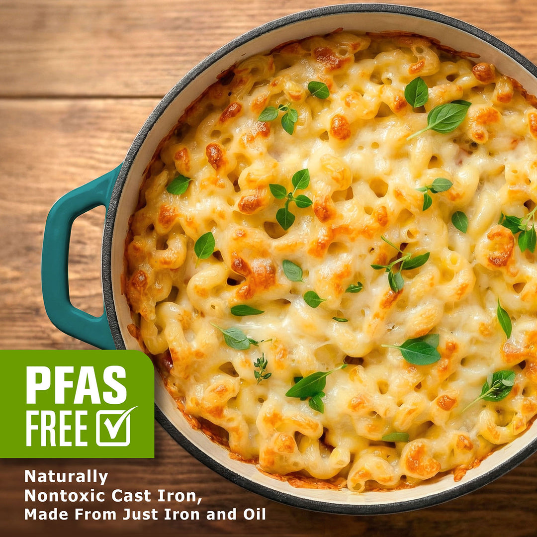 Macaroni and cheese dish in a cast iron skillet on a wooden surface, with PFAS-free label.