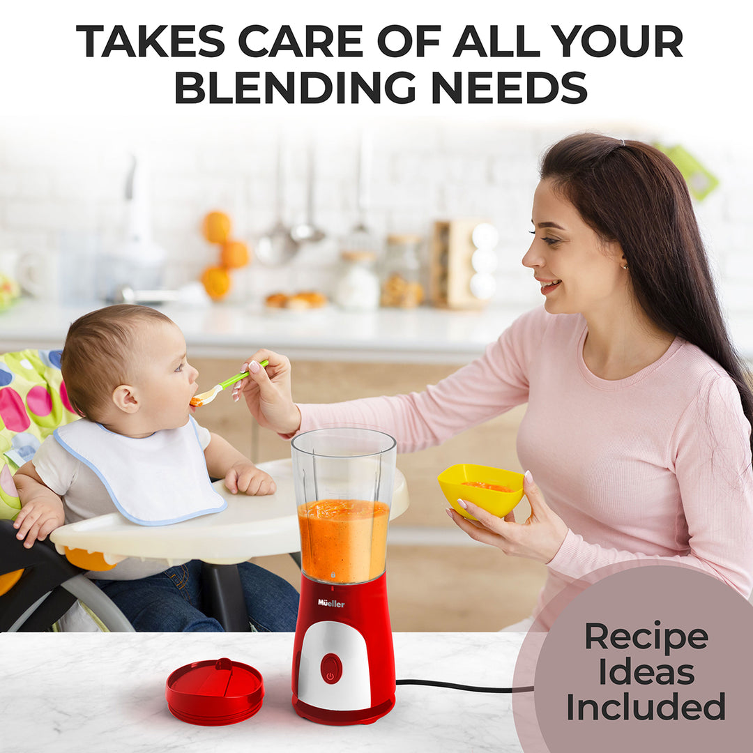Woman feeding a baby with a spoon in a kitchen setting, next to a blender.