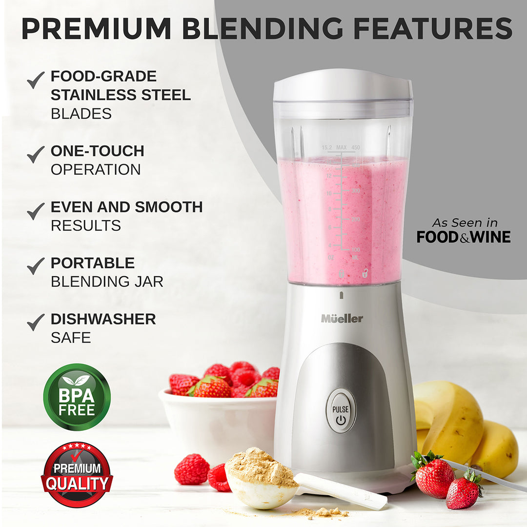 Mueller Personal Blender white with pink smoothie, surrounded by fruits and ingredients, on a light background.