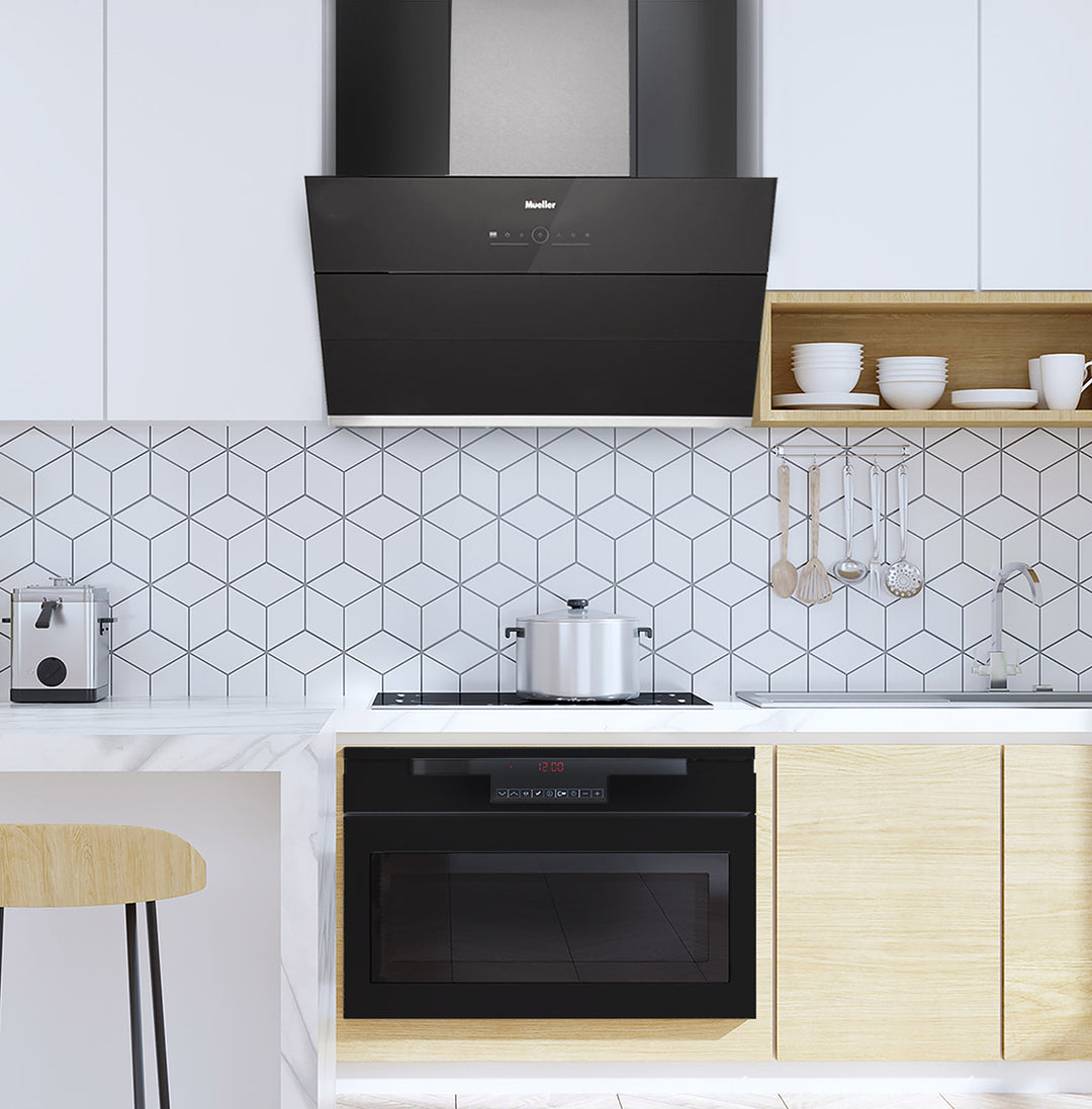 Modern kitchen with black range hood, oven, and geometric tile backsplash.