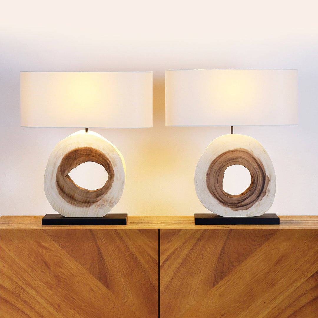 Two table lamps with wooden bases on a wooden surface