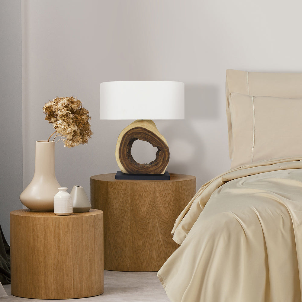 Wooden nightstands with decorative items next to a bed